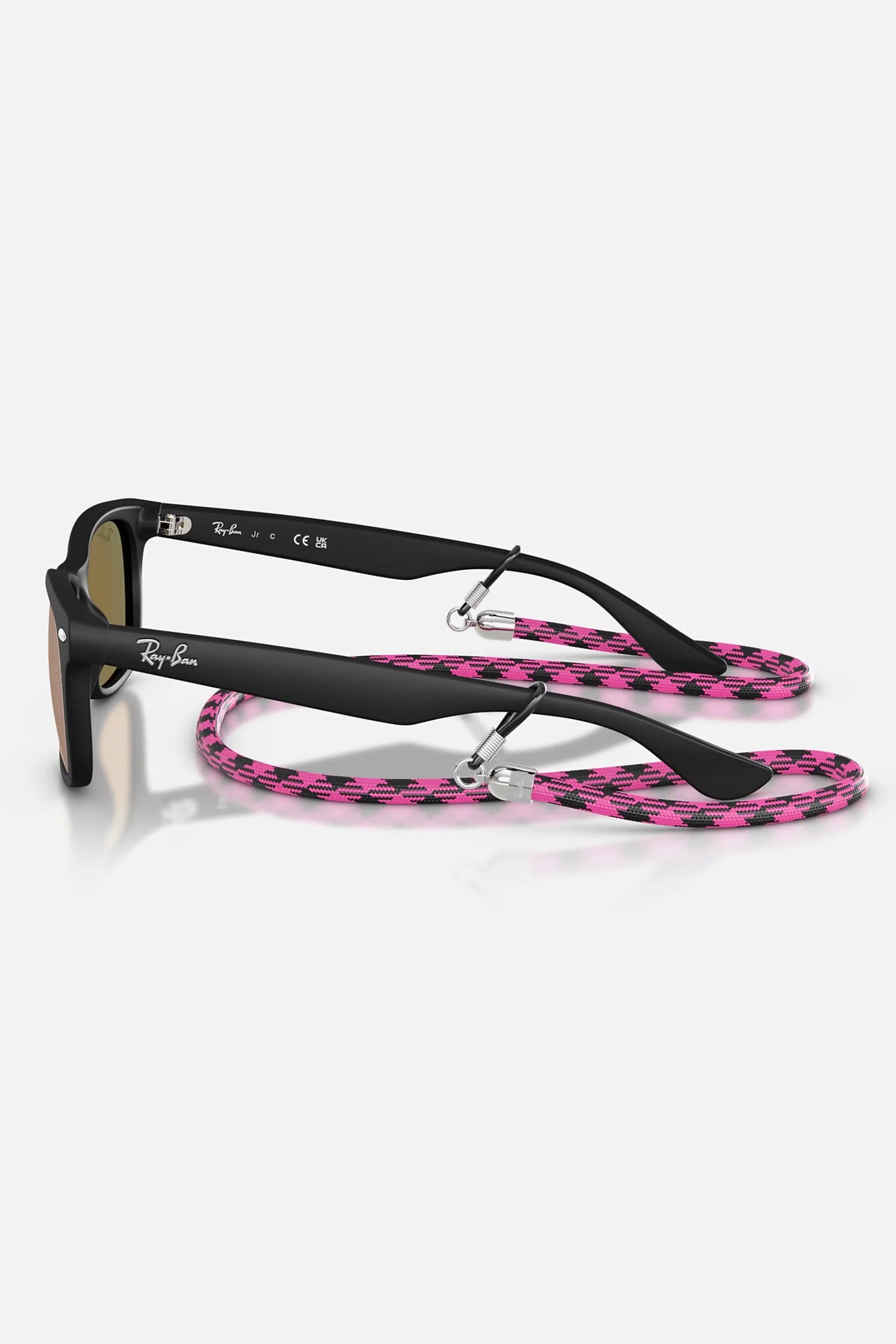 Occhiali da sole Ray-Ban RJ9052S 7028/7J Junior, montatura nero opaco su trasparente con lenti rosa specchiate.